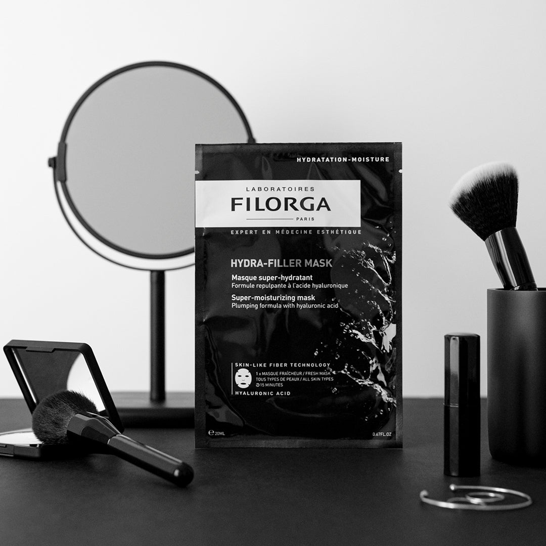 Single FILORGA HYDRA-FILLER MASK outer package on a make-up vanity with mirror
