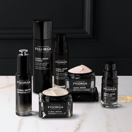 Four GLOBAL-REPAIR anti-aging skincare products on black, grey, and white background
