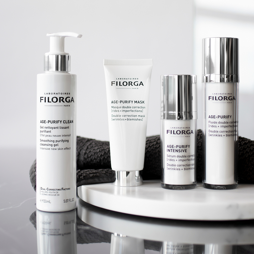 Filorga Age-Purify Clean, Mask, Intesnsive, and Fluid standing up on marble counter
