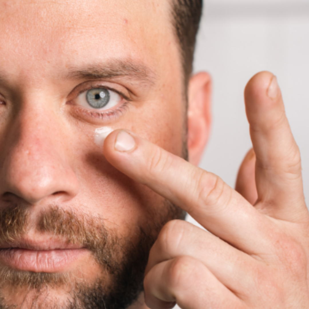 Man applying Filorga anti-aging eye cream to reduce signs of fatigue