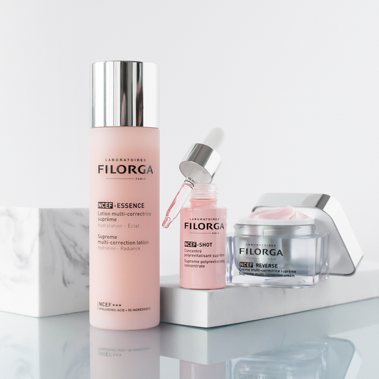 NCEF-Essence, NCEF-Shot serum, and NCEF-Reverse face cream on marble counter