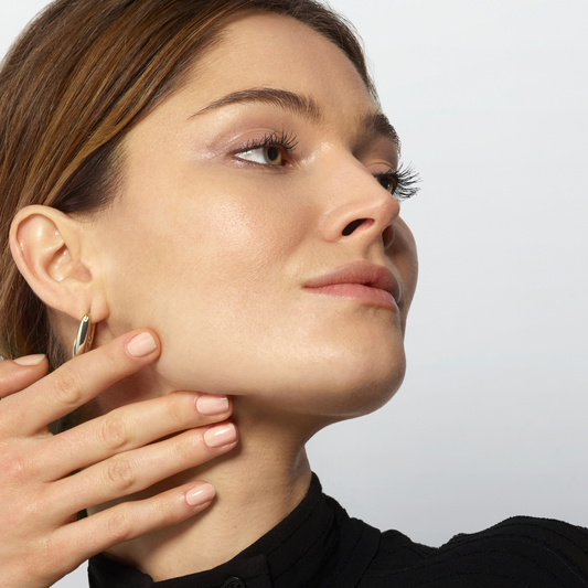 Woman caressing the skin on the right side of her face