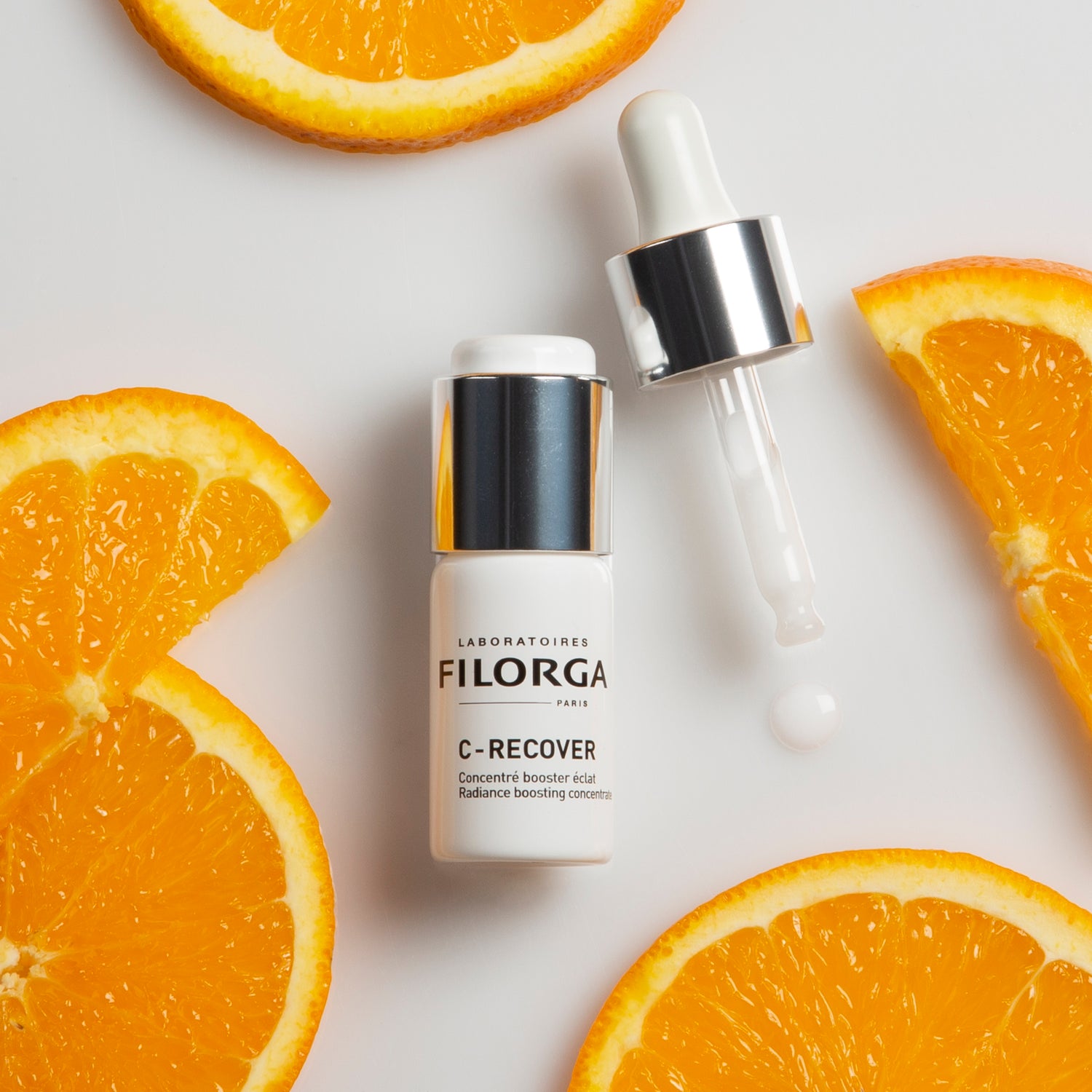 FILORGA C-RECOVER white bottle with dropper surrounded by orange slices 