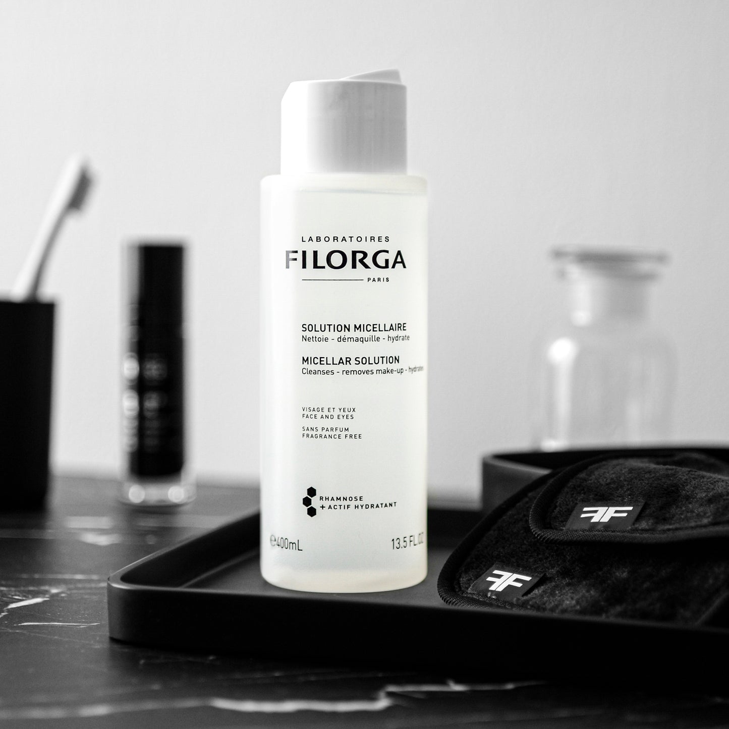 FILORGA MICELLAR SOLUTION on a black tray with double F logo cloths on a marble bathroom counter