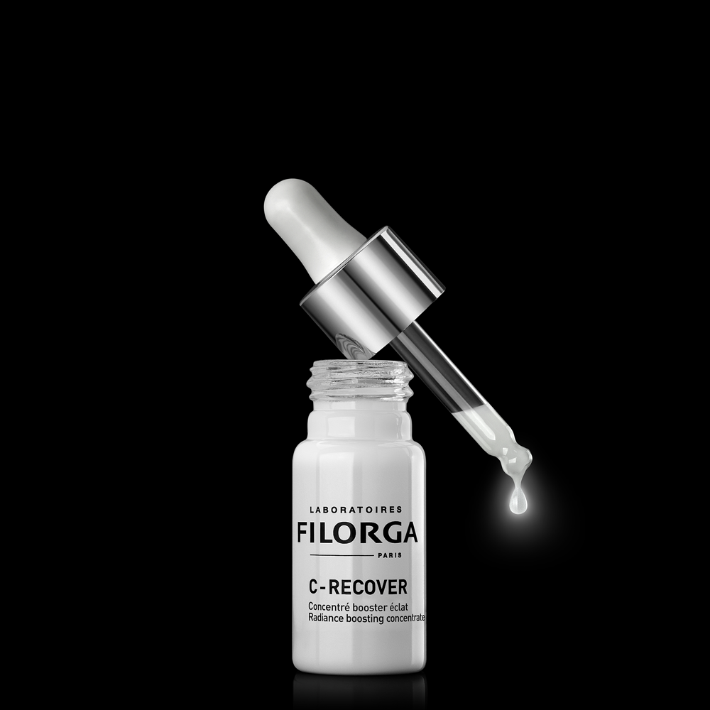 Open single bottle of FILORGA C-RECOVER radiance boosting concentrate with dropper resting on top