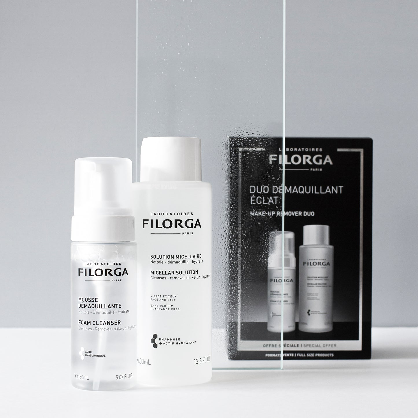 FILORGA CLEANSING DUO bottles with box next to steamed glass panel