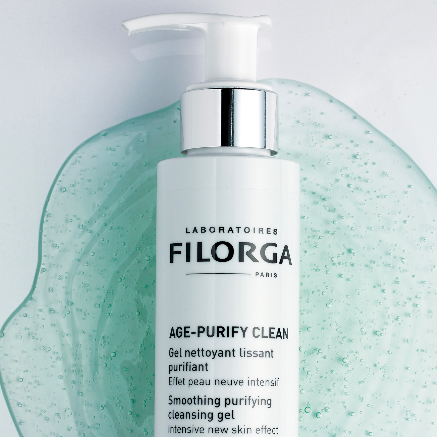 FILORGA AGE-PURIFY CLEAN pump bottle with green gel cleanser texture background